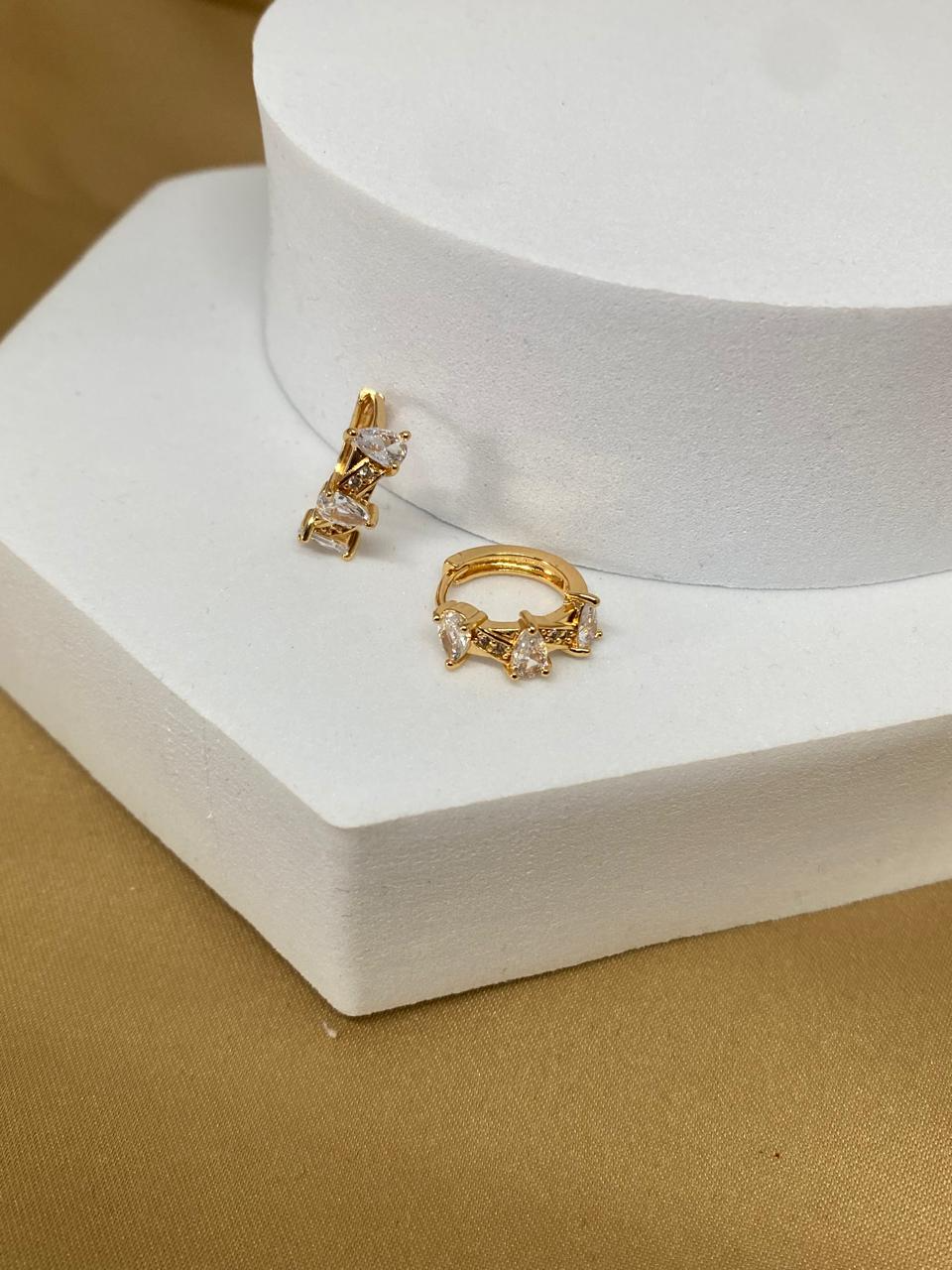 A26458 Arete triple gota blanca.      Material: Oro laminado 18 k.